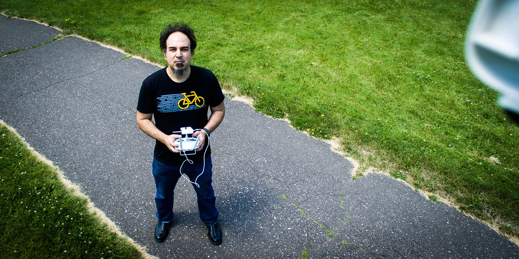 Andrew Charon outdoors with a drone controller